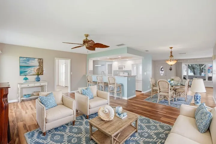 Virtually staged family room with bar stools at the kitchen counter.