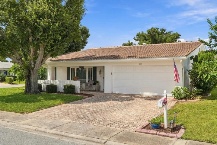 The driveway has elegant pavers leading the home.