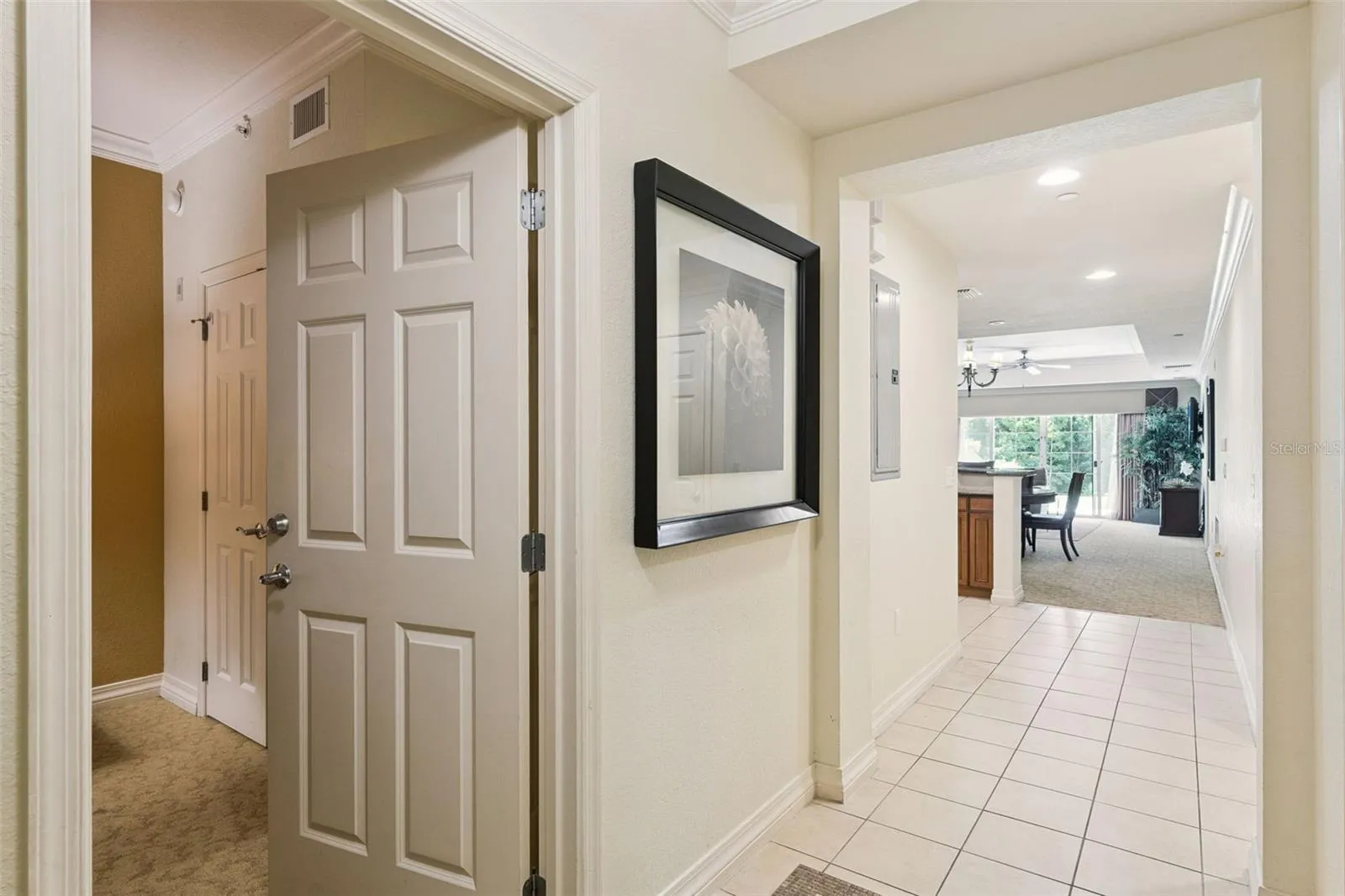Entry Foyer: Welcoming entryway featuring neutral tile flooring, crisp trim work, and direct sightlines into the open-concept living area.