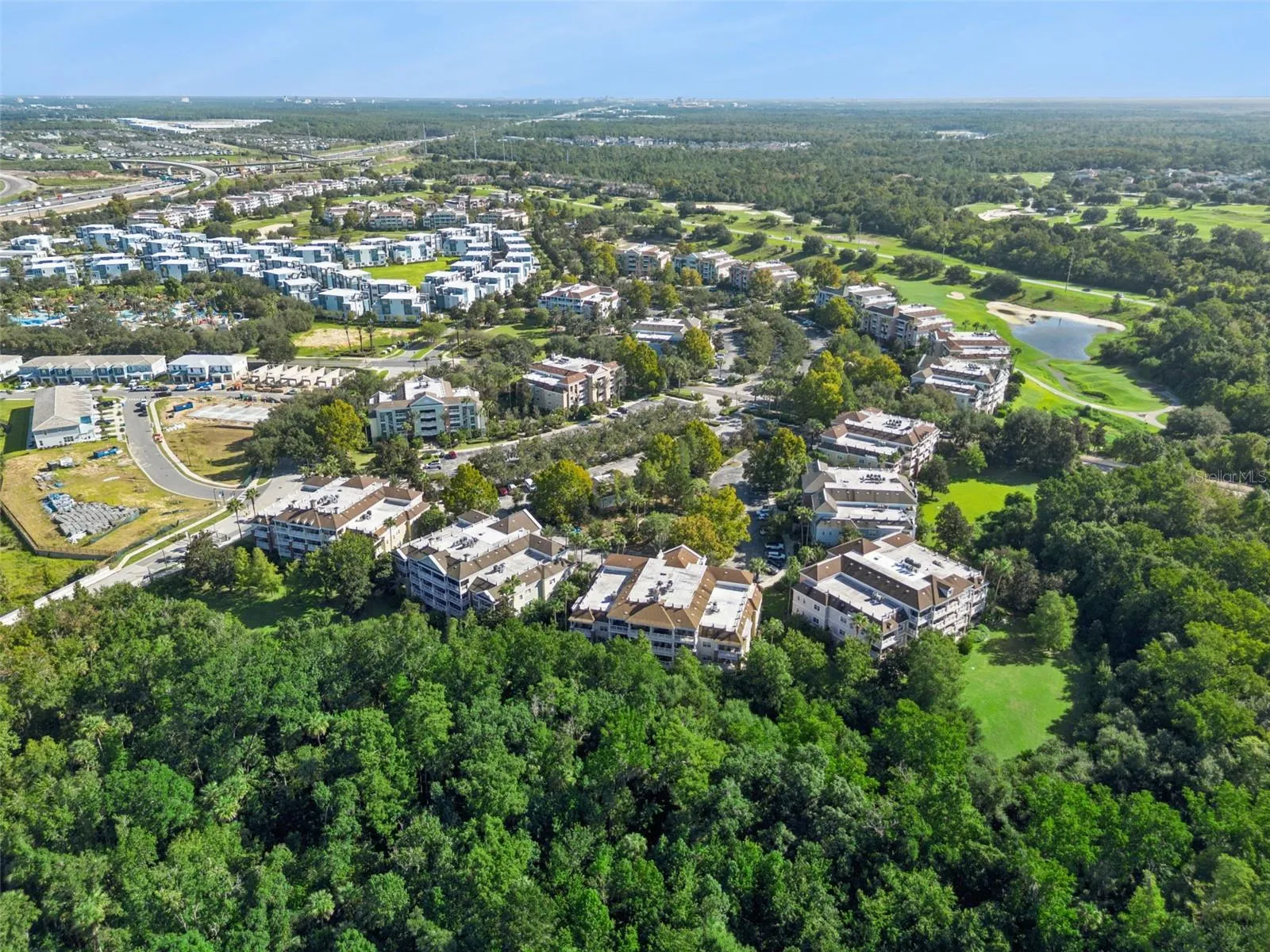 Panoramic Conservation View: Panoramic aerial capture highlighting the property's prime position bordering dense conservation forest and neighboring golf course communities.