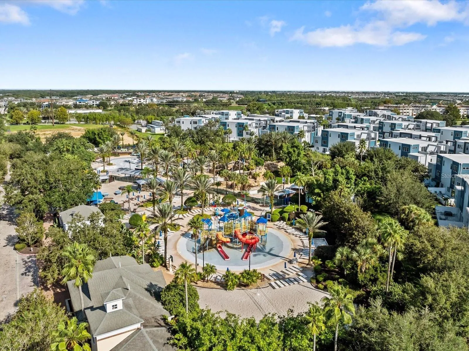Resort Water Park &amp; Community View: Broad aerial view highlighting the water park amenities, clubhouse grounds, and surrounding residential developments.
