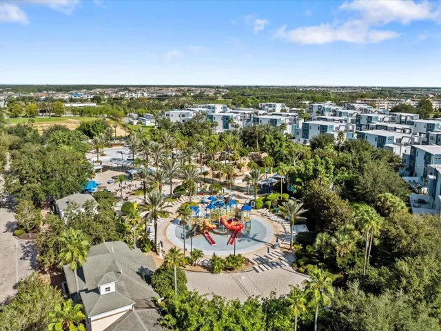 Resort Water Park &amp; Community View: Broad aerial view highlighting the water park amenities, clubhouse grounds, and surrounding residential developments.
