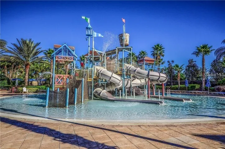 Interactive Splash Park Playground: Multi-level splash park playground equipped with interactive water slides, climbing nets, and shallow splash areas.