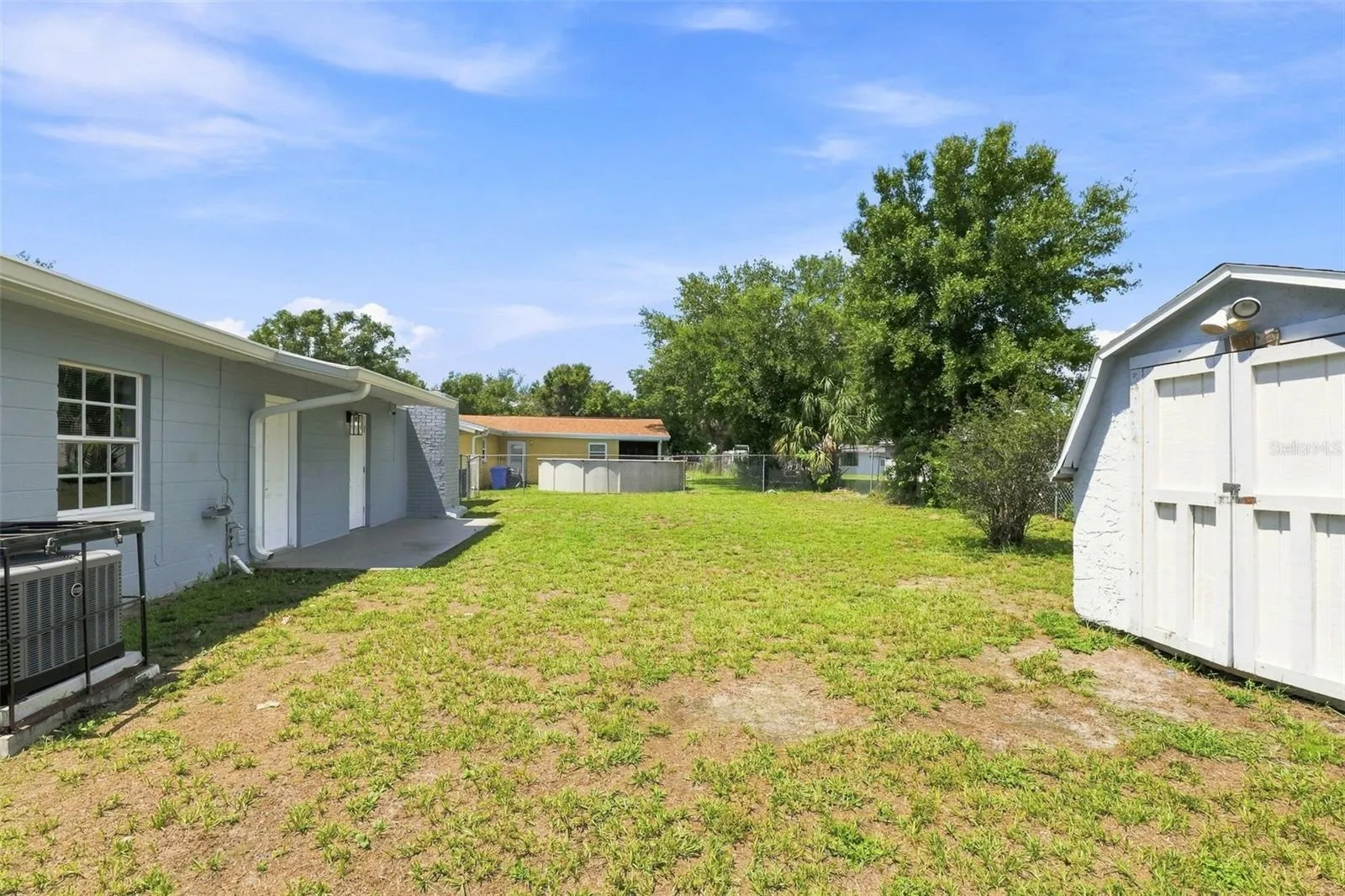Backyard featuring an outdoor shed for storage or workshop use.