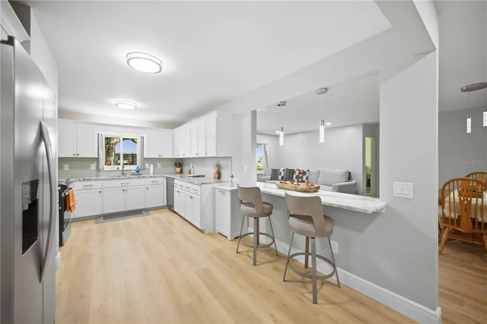Spacious Kitchen with bar seating area overlooking living room