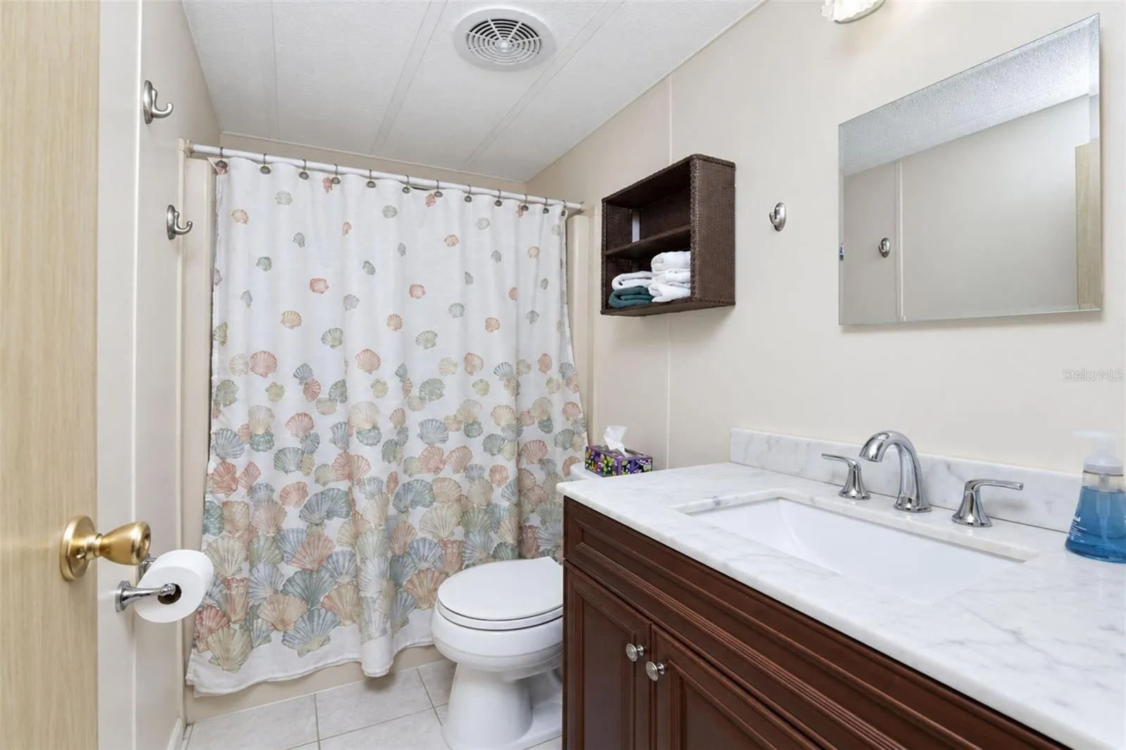 Guest bath has an updated vanity w/solid surface countertop and updated toilet.