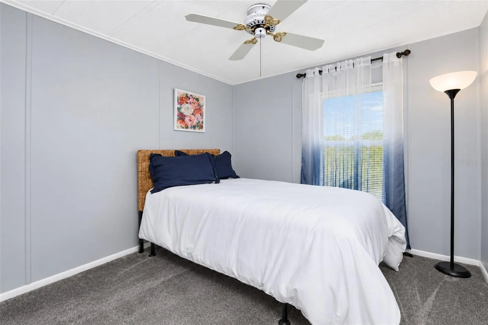 Guest bedroom also has carpeted flooring.