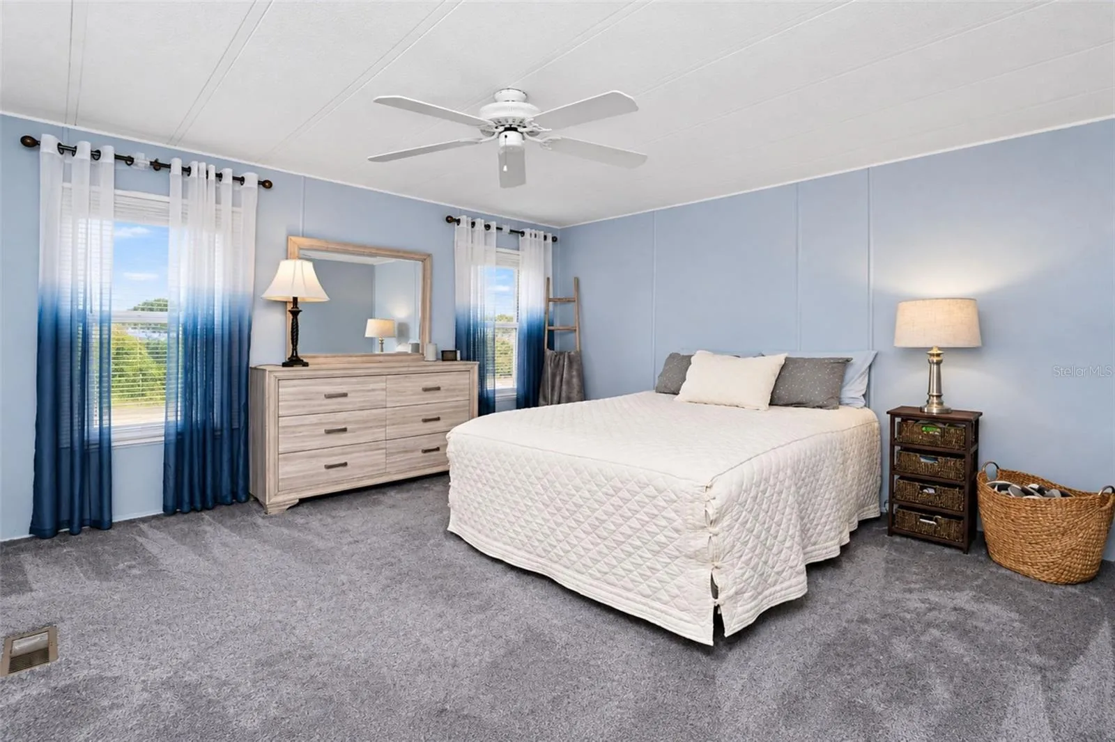 Spacious primary bedroom has carpeted flooring - nice on your feet on those cool mornings!