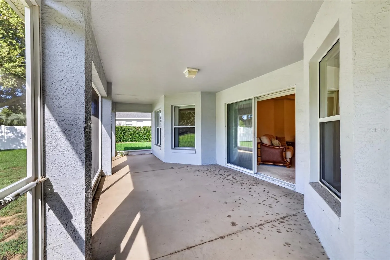 The screened lanai provides a generous covered outdoor living area with direct access to the backyard.