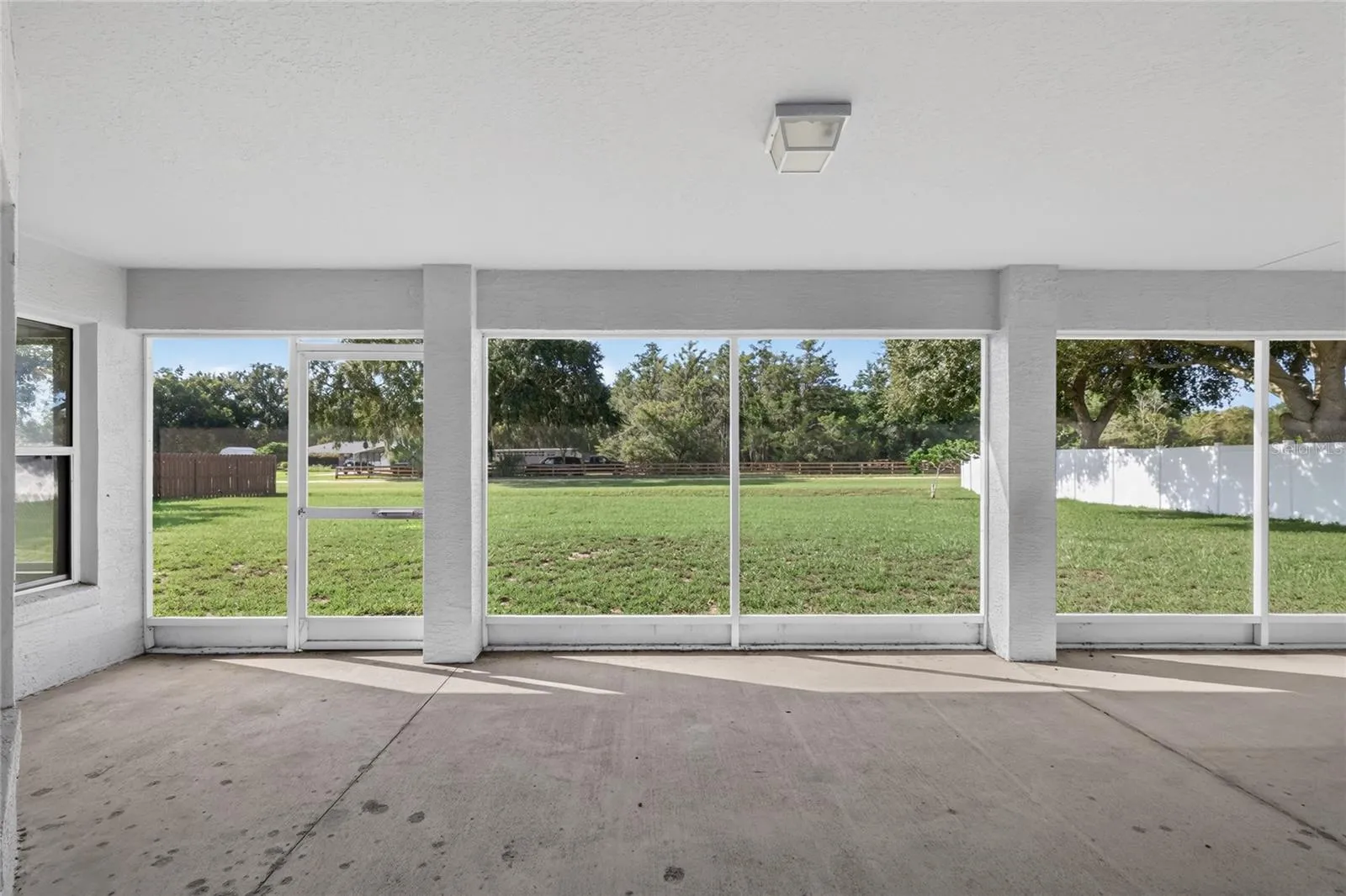 Enjoy views of the spacious backyard from the large screened lanai.
