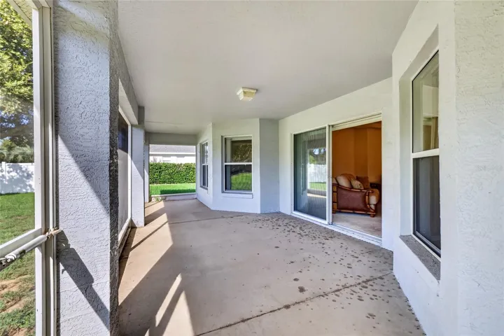 The screened lanai provides a generous covered outdoor living area with direct access to the backyard.