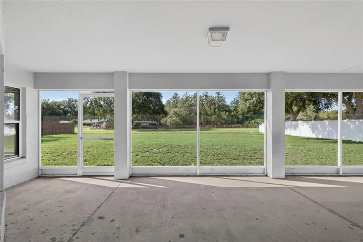 Enjoy views of the spacious backyard from the large screened lanai.