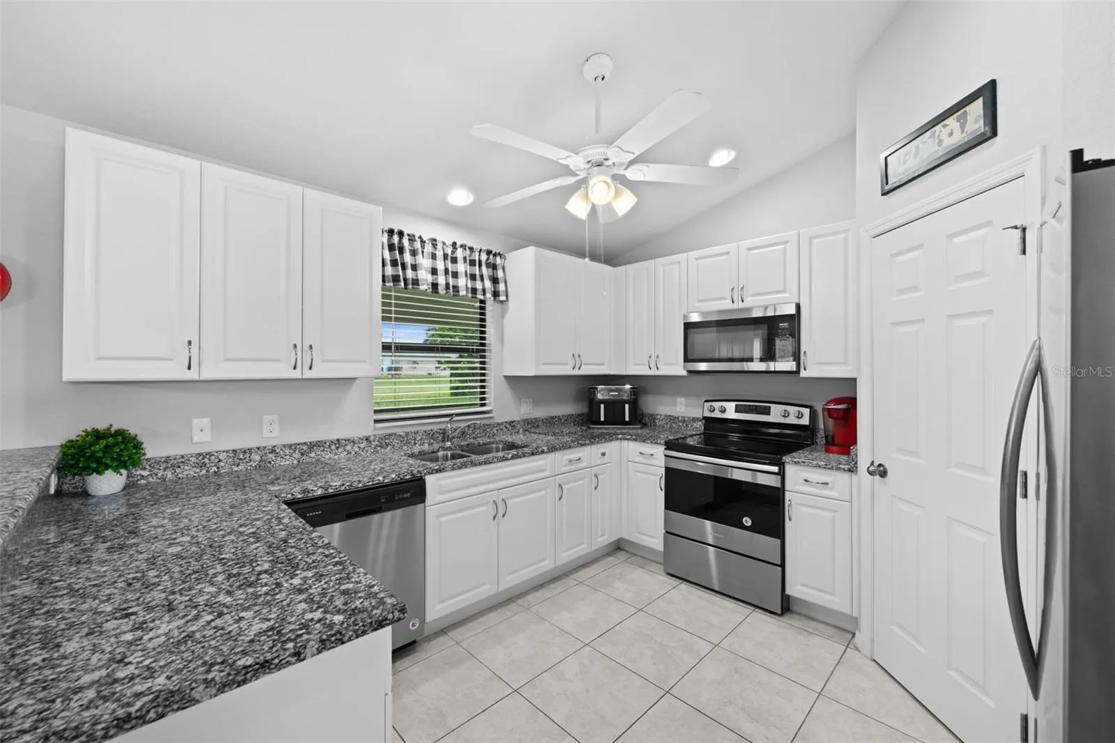 A well appointed kitchen with stainless appliances and lots of cabinets