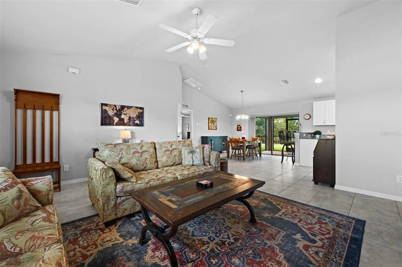 From the front, looking through the living room, to the dining room, screened lanai, and canal behind