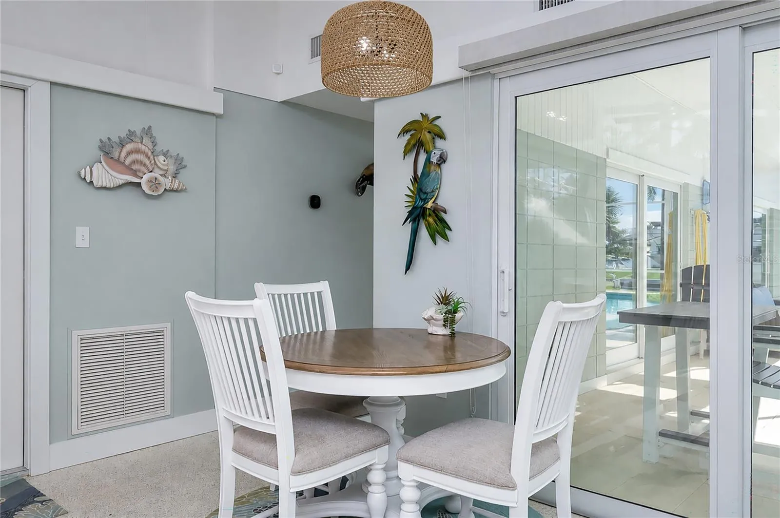 Dining area, with pool view. Smart Thermostat on wall.
