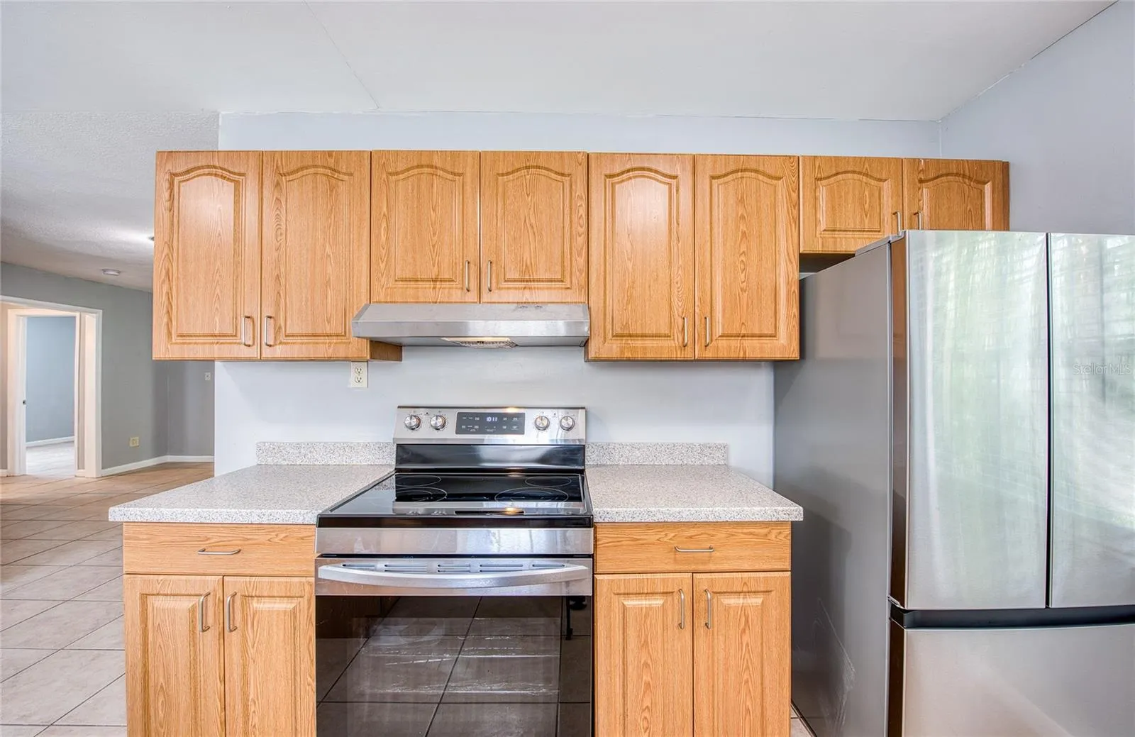 Brand new french door refrigerator and brand new range and range hood.