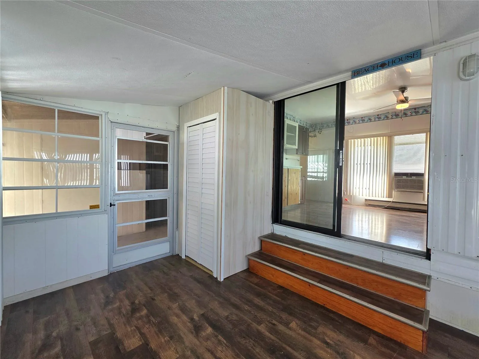 Florida room has a storage closet and back door to the laundry/utility room. Slider to the central dinind area.