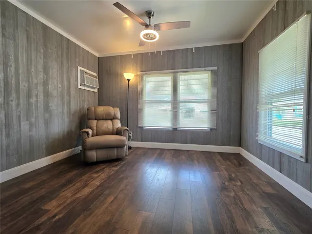 Front living room with decorative wood look wall board.
