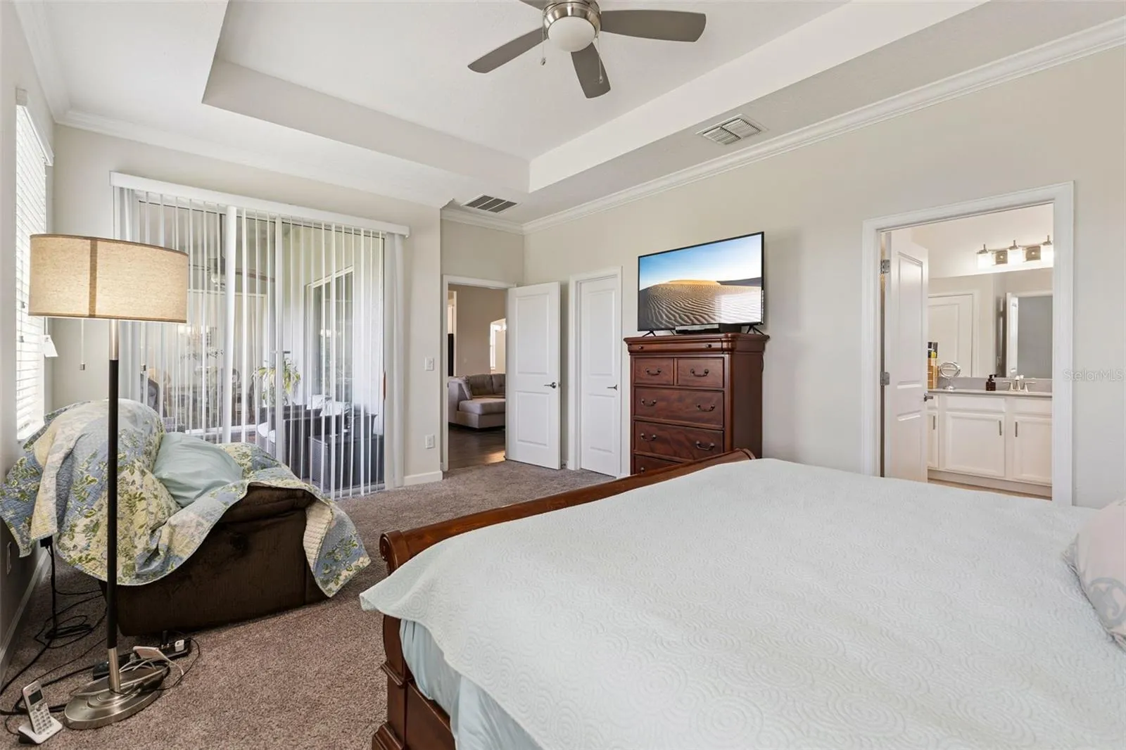 Primary Bedroom offers a Large Walk-in Closet and Sliding Glass Doors to the Lanai