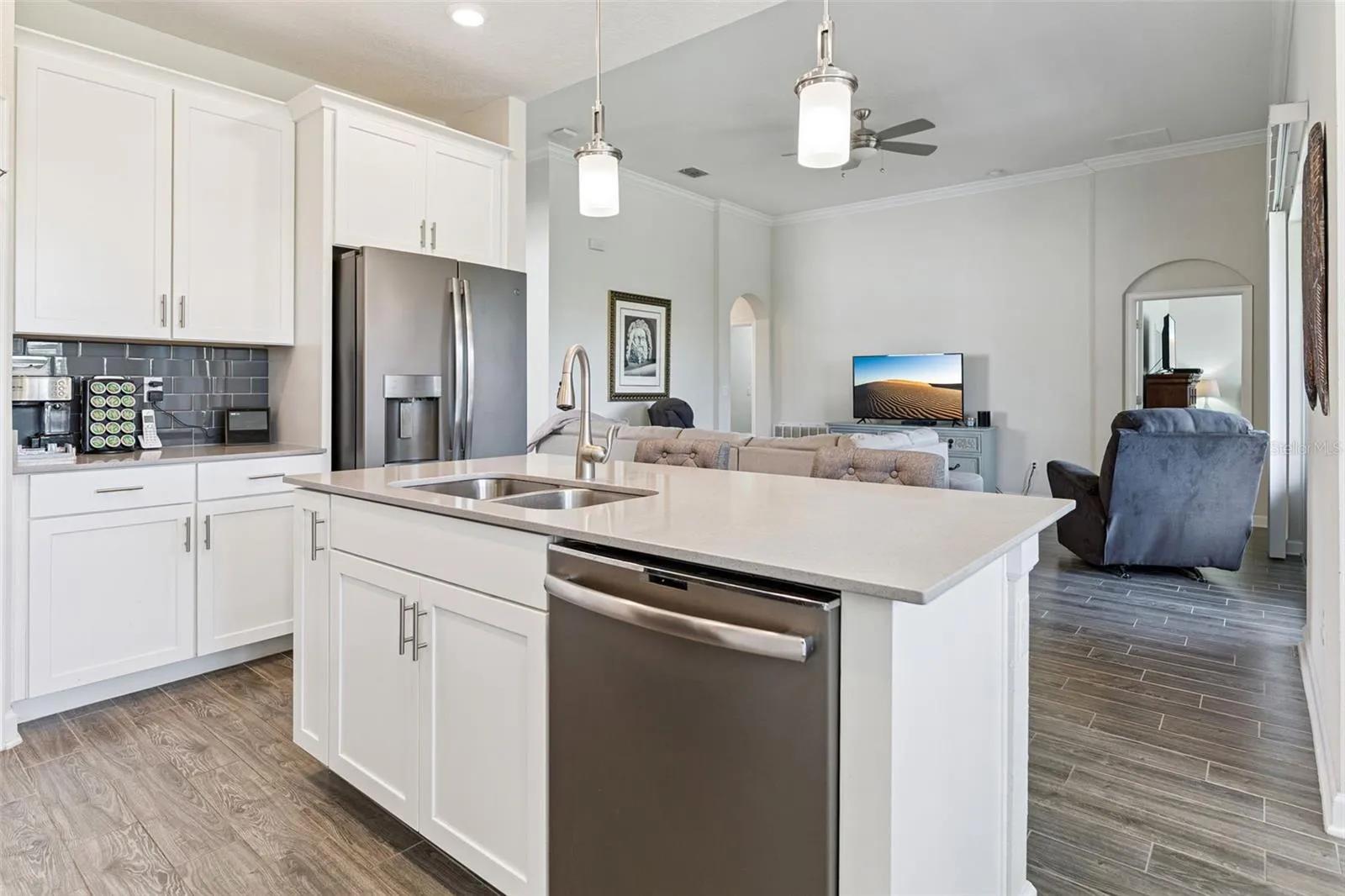 Center Island with Quartz Countertops and Pendant Lighting
