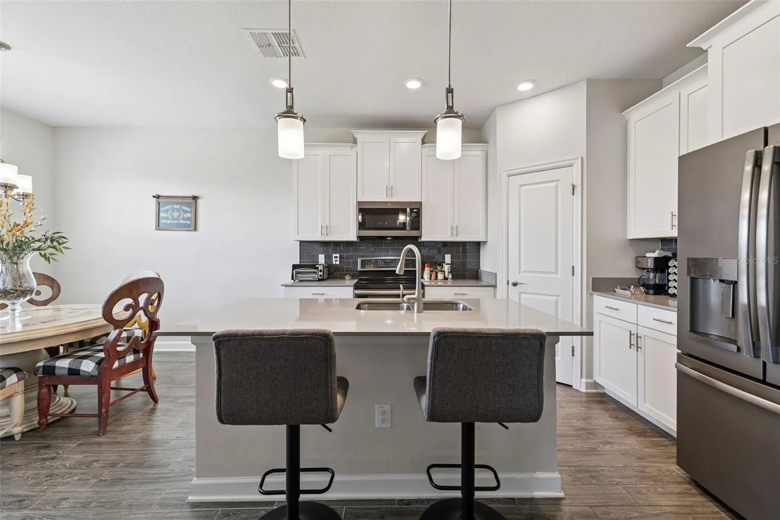 Gourmet Kitchen with White Shaker Cabinets, Crown Molding and Brushed Nickel hardware