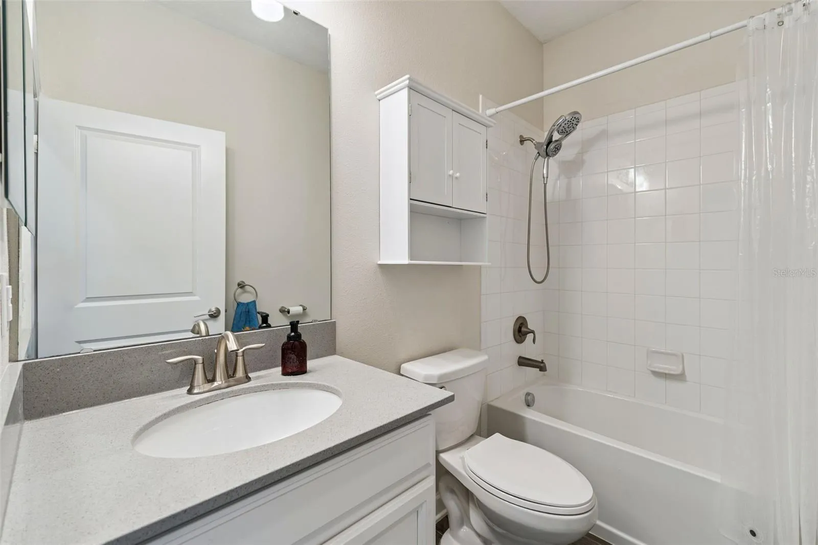 Bathroom 2 features a comfort height vanity with quartz countertops and a tub/shower unit