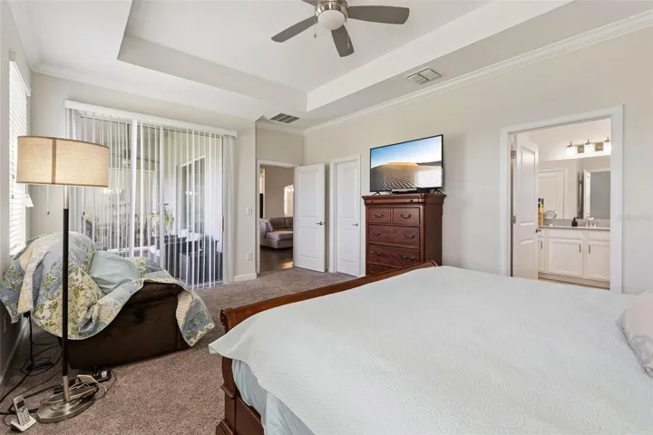 Primary Bedroom offers a Large Walk-in Closet and Sliding Glass Doors to the Lanai
