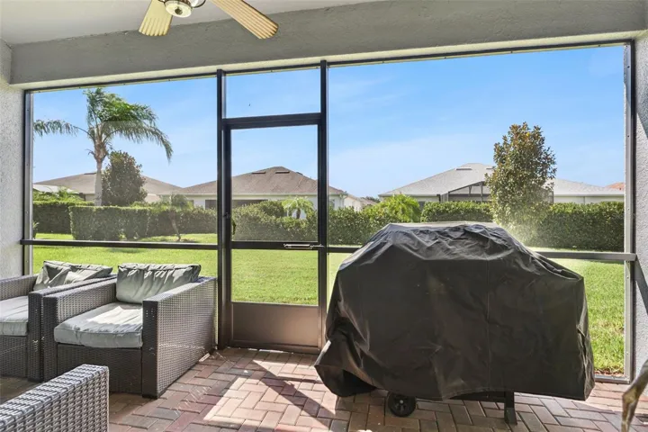 Screened-in lanai, beautifully finished with pavers and offering a peaceful space to relax, entertain, and enjoy the Florida lifestyle