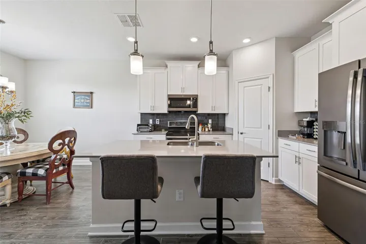 Gourmet Kitchen with White Shaker Cabinets, Crown Molding and Brushed Nickel hardware