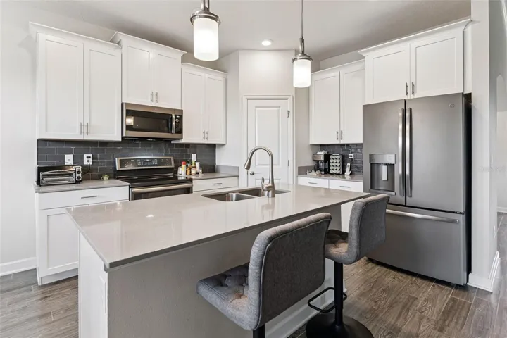 Timeless white shaker cabinetry accented with crown molding and brushed-nickel hardware