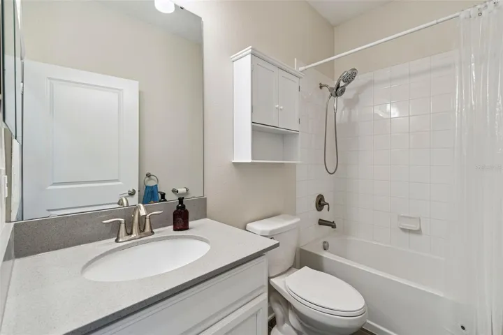 Bathroom 2 features a comfort height vanity with quartz countertops and a tub/shower unit