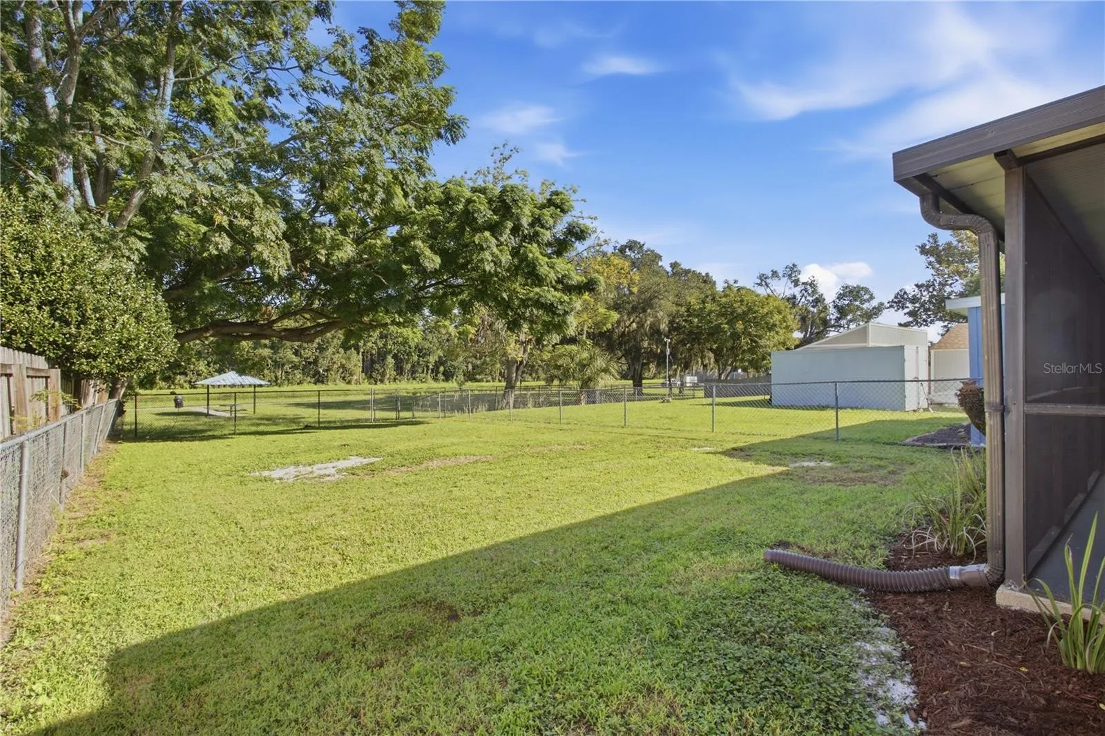 Mature trees at end of backyard with picnic table and cool breezes from the river