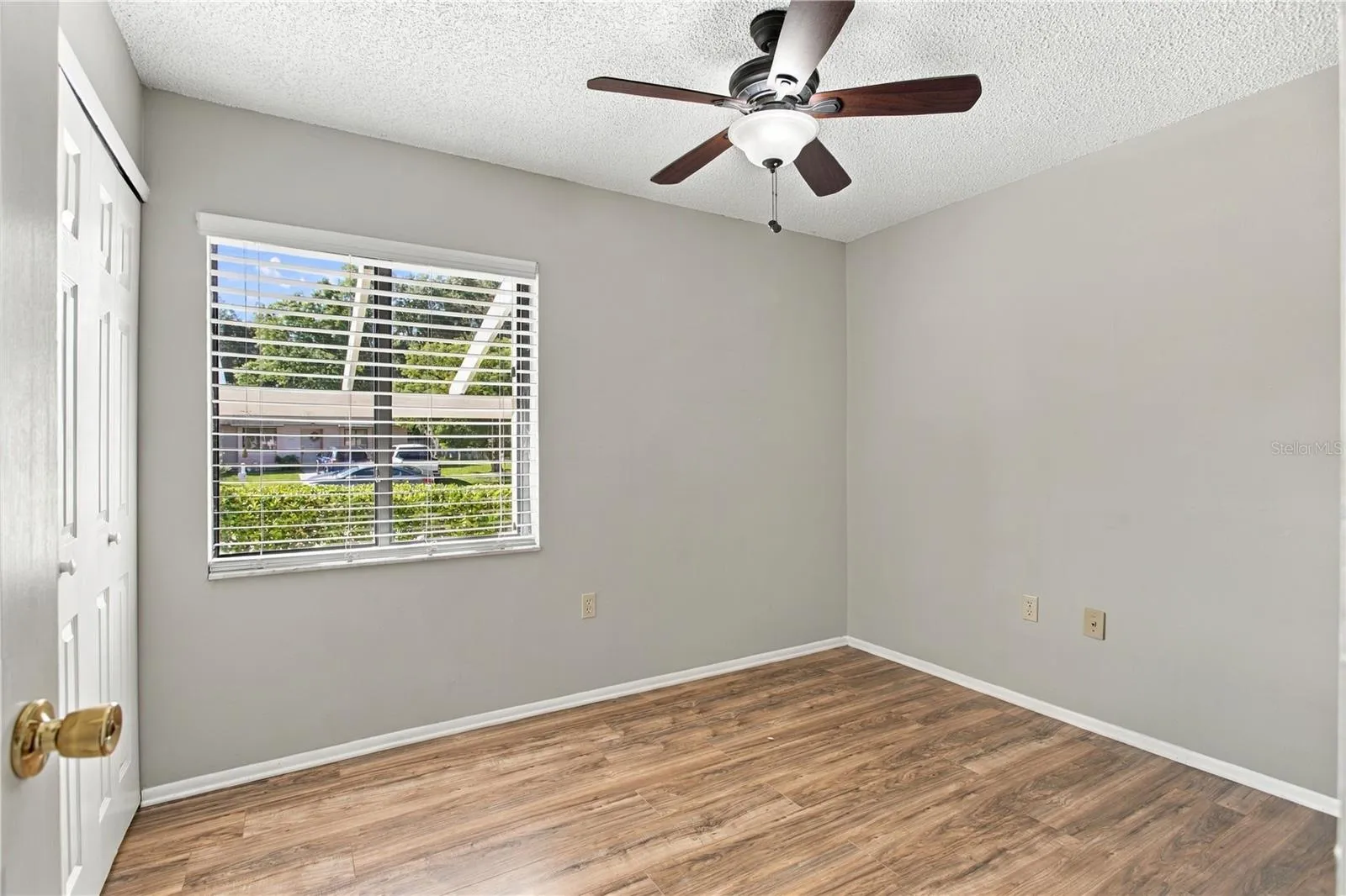 Bedroom #2 with vinyl floor and ceiling fan