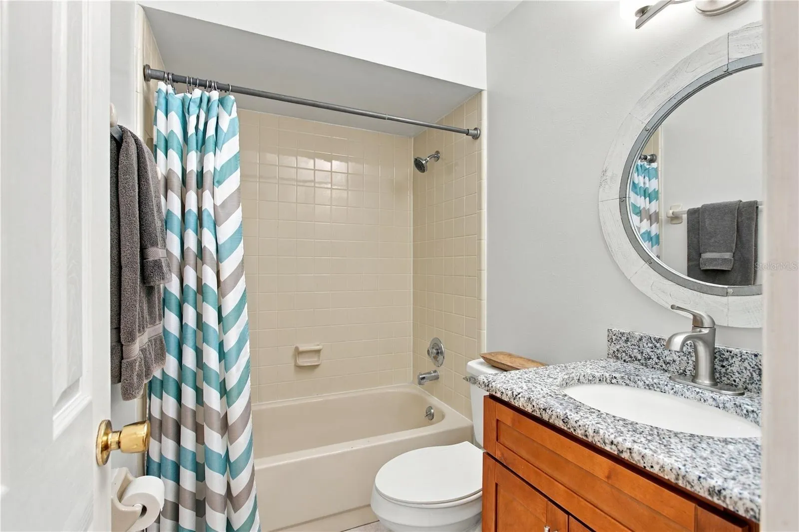 Bathroom #2 with updated vanity/granite countertop and decorative mirror