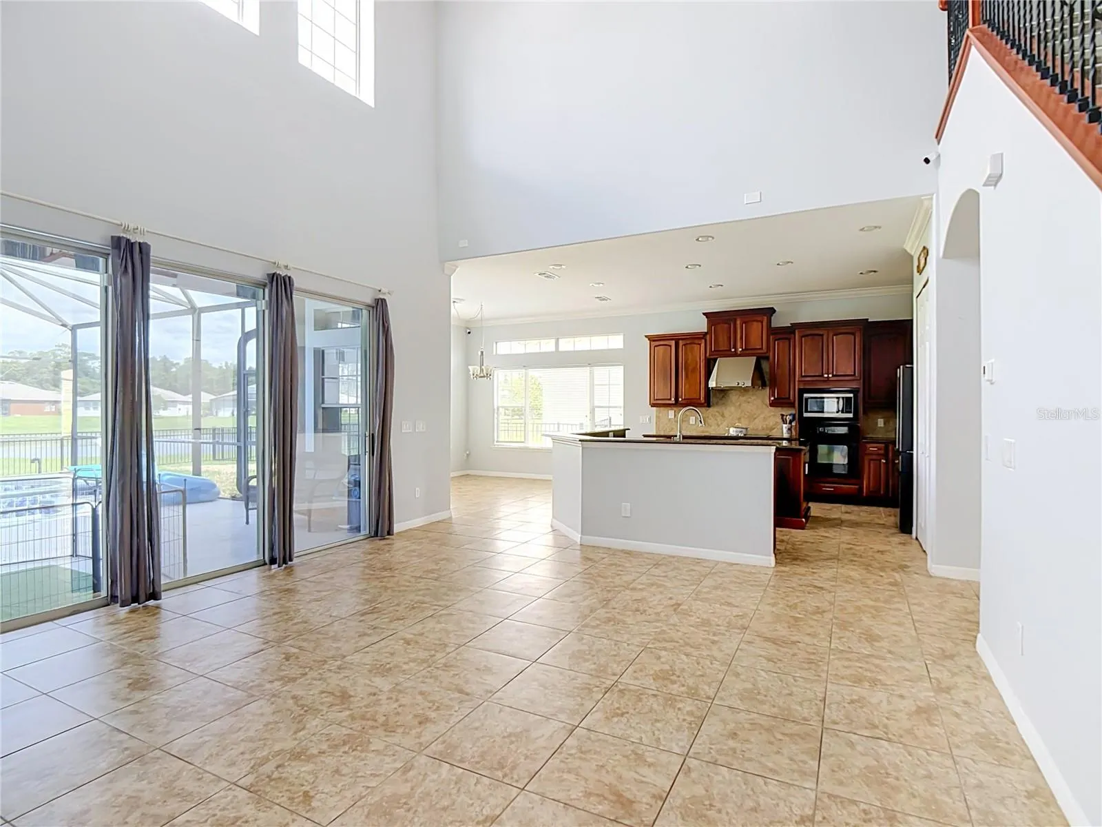 family room towards kitchen with sliders leading onto pool deck
