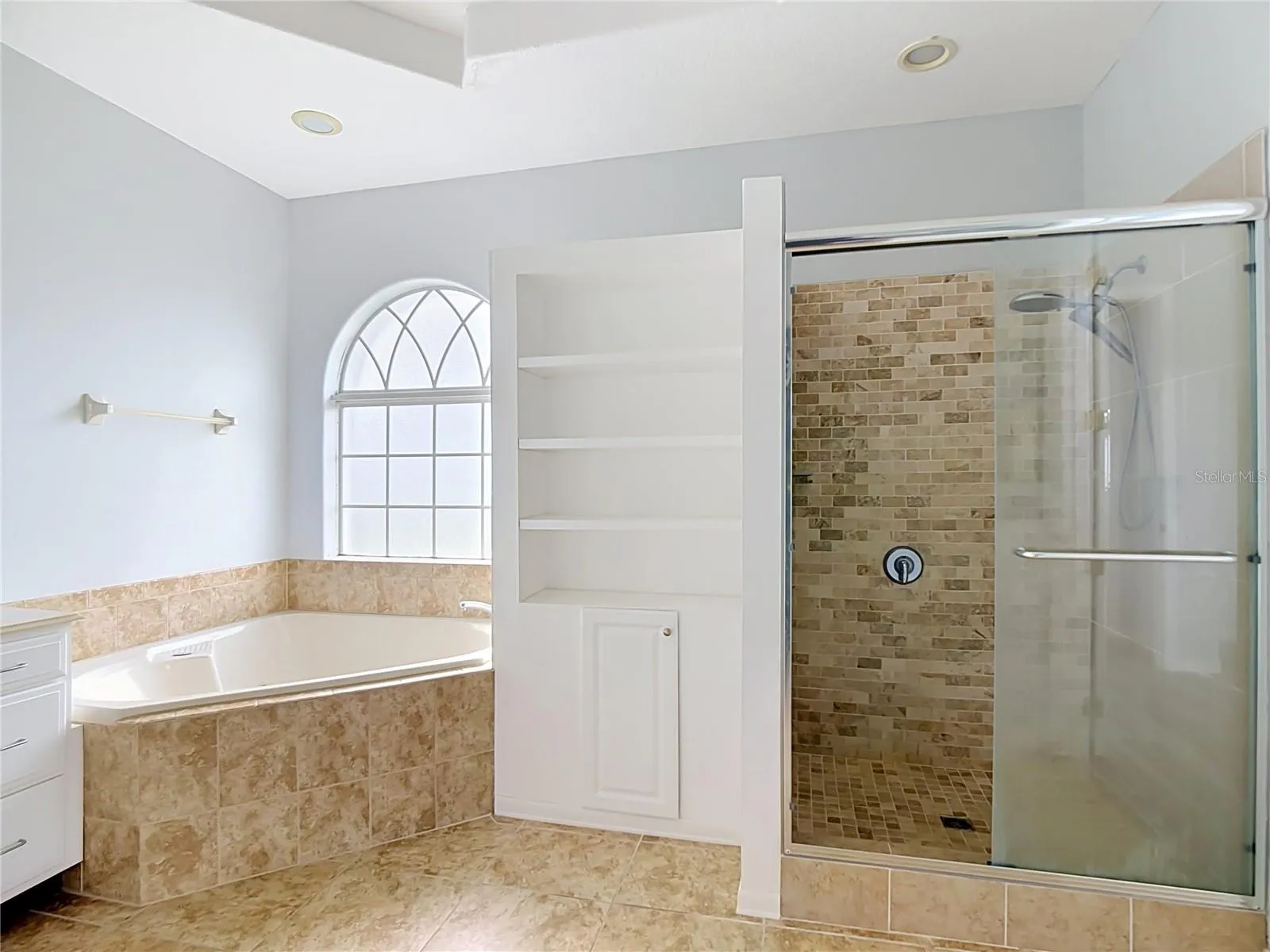 primary en-suite bath with tub and separate shower