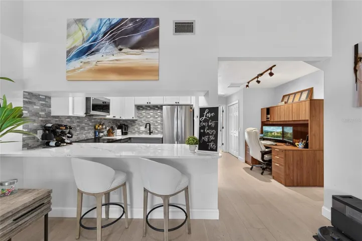 Breakfastbar with view of the Dinette, which currently is used as a home office nook.