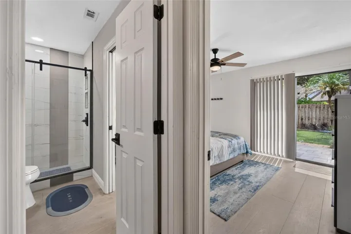 View of both the primary bath and bedroom.