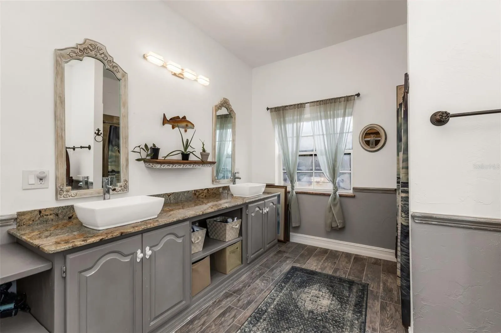 Upstairs bathroom with dual sinks and shower
