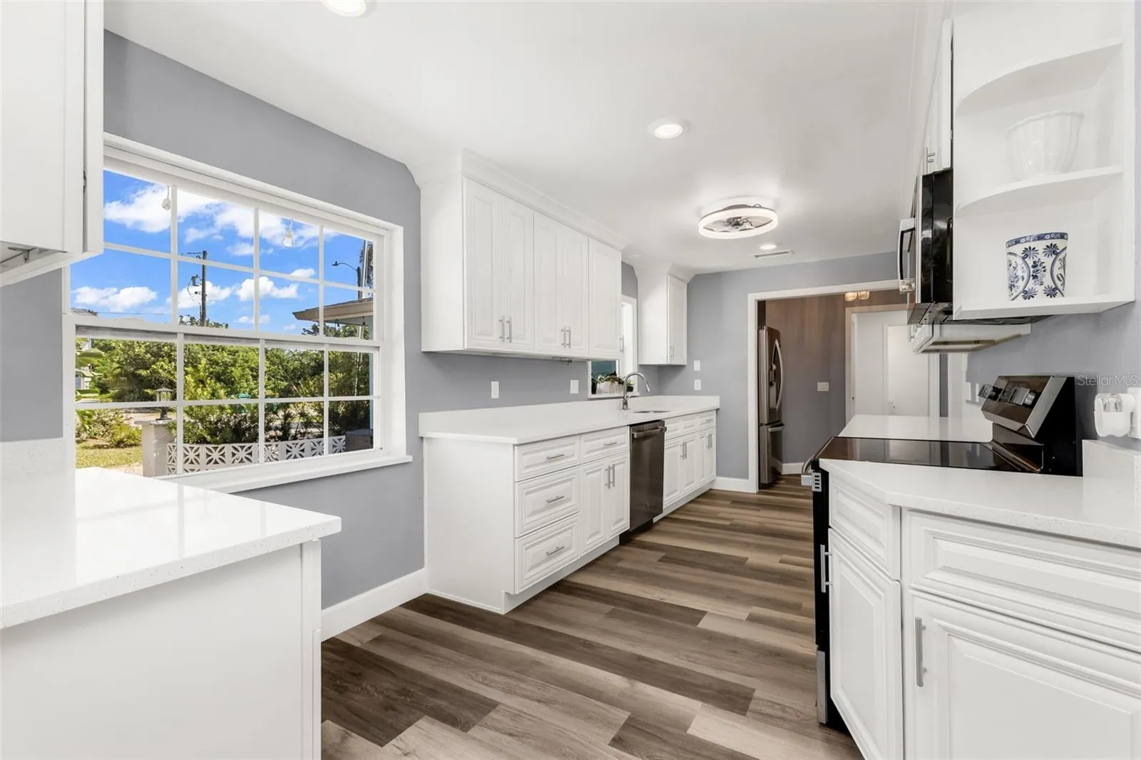 Kitchen with large window and window above sink