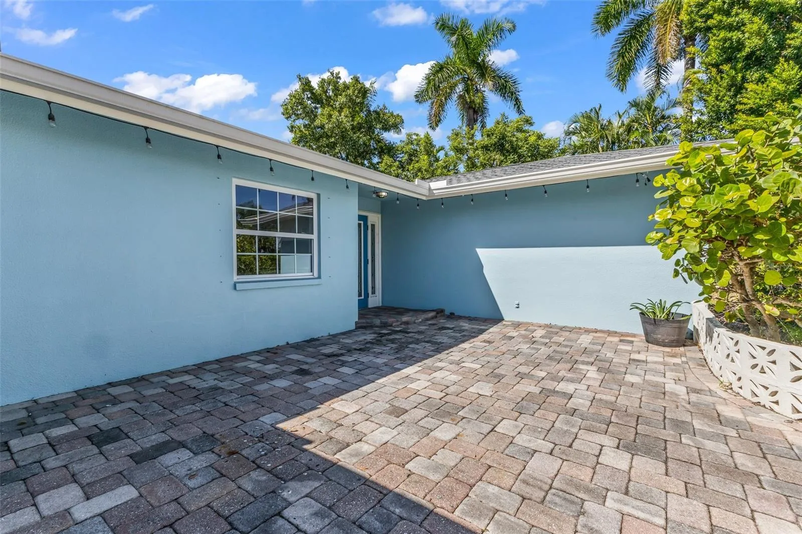 Large paved front entry to home