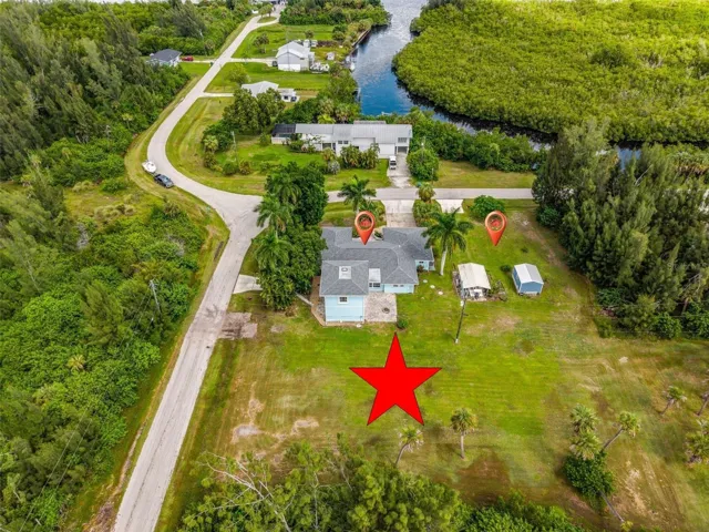 Aerial property view with home and back yard