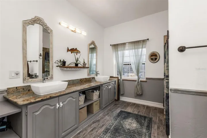 Upstairs bathroom with dual sinks and shower
