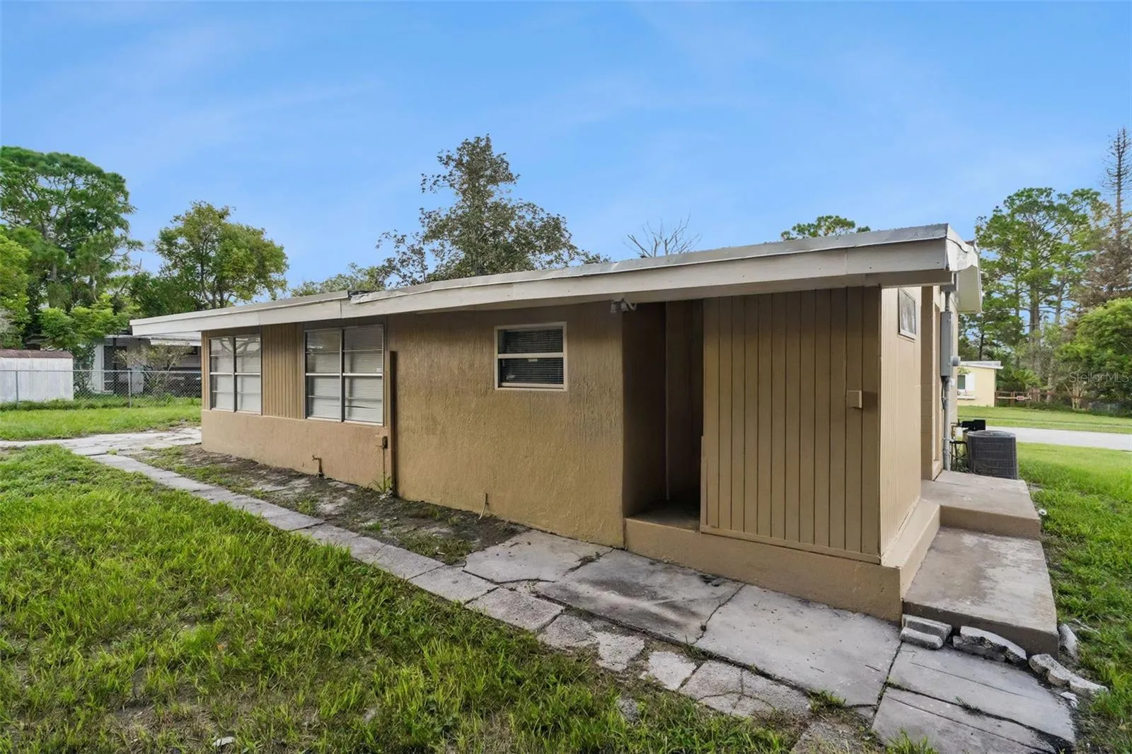 Back Exterior has breezeway to storage room and laundry area