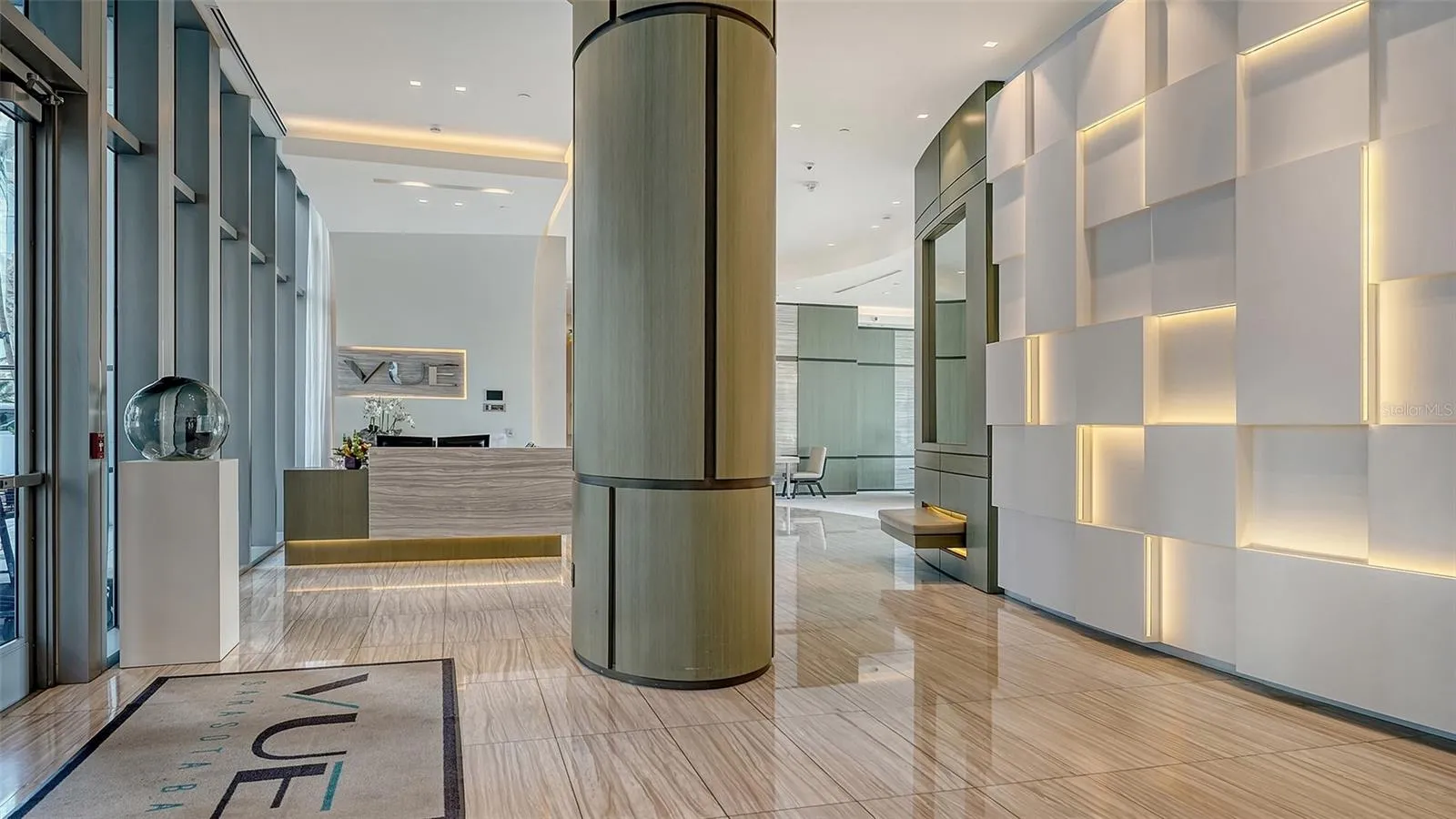 Welcome to The VUE, where a grand lobby with soaring ceilings creates an impressive first impression of luxury and sophistication.