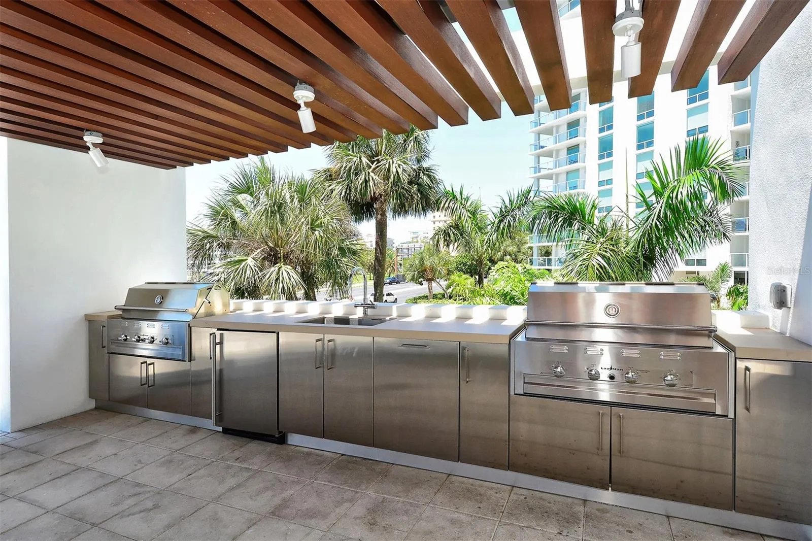 Featuring two stainless steel grills, the resident outdoor kitchen invites you to unleash your inner chef and entertain in style.