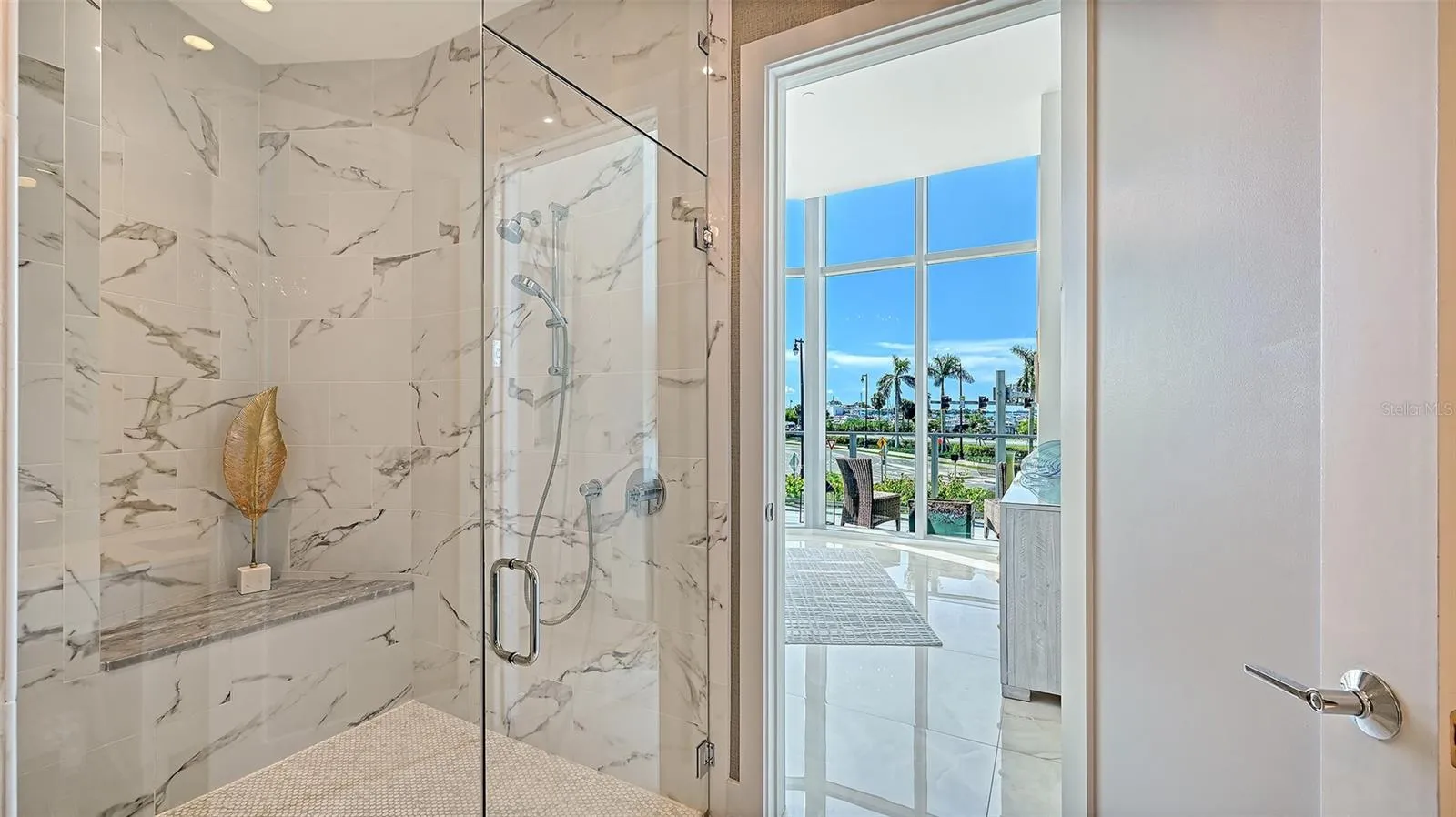 A luxurious, oversized walk-in shower enclosed in sleek glass, offering a spa-inspired bathing experience.