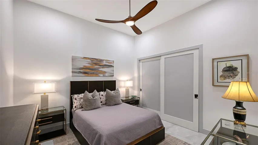 A generous second bedroom featuring custom-designed closets and refined comfort.
