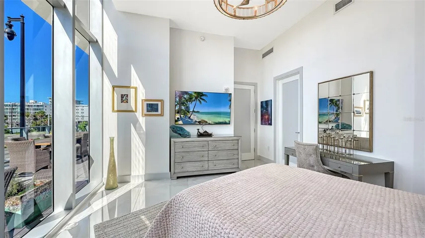 Unwind in the comfort of your luxurious primary suite while enjoying your favorite shows.
