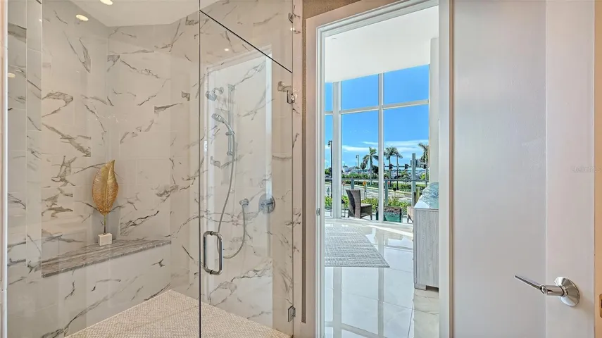 A luxurious, oversized walk-in shower enclosed in sleek glass, offering a spa-inspired bathing experience.